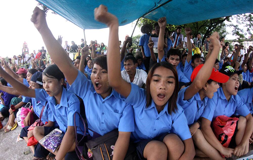 Workers from a cold storage shout slogans as they stage a sit-in strike, calling for fair treatment, labor rights and complaining of work insecurity in downtown Yangon, Myanmar.