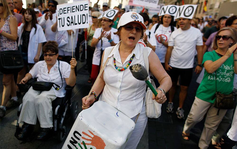 Protestors shout slogans and carry a banner reading