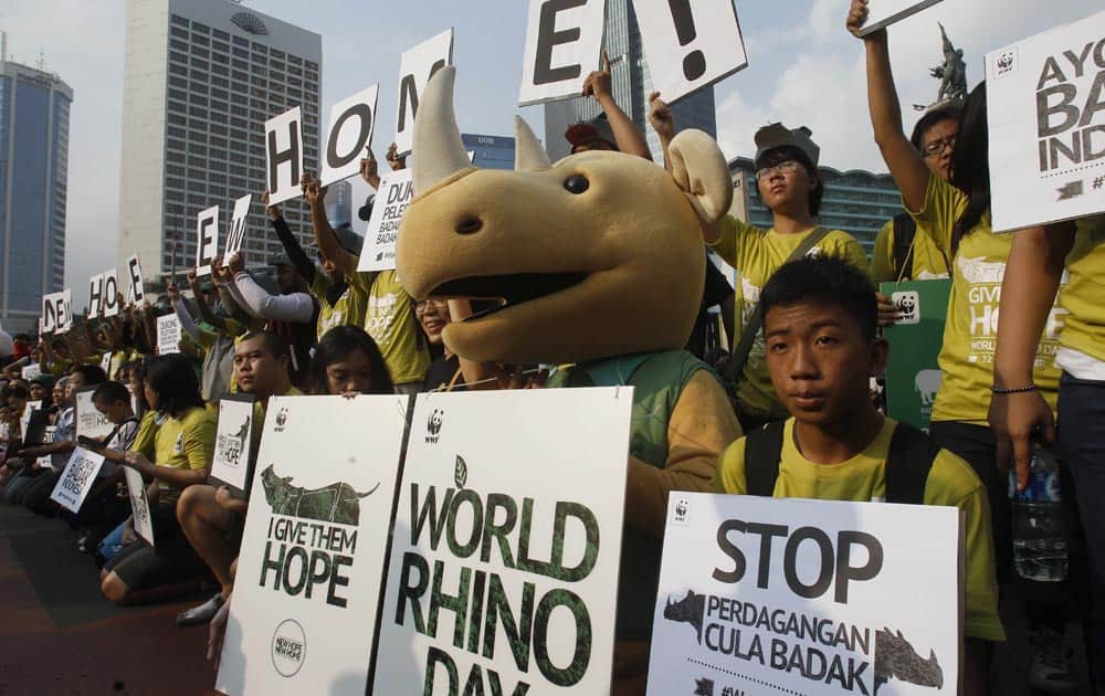 Activists hold banners during World Rhino Day in Jakarta. According to WWF, some 50 rhinoceros including calves are confirmed inhabiting at Ujung Kulon National Park in West Java.