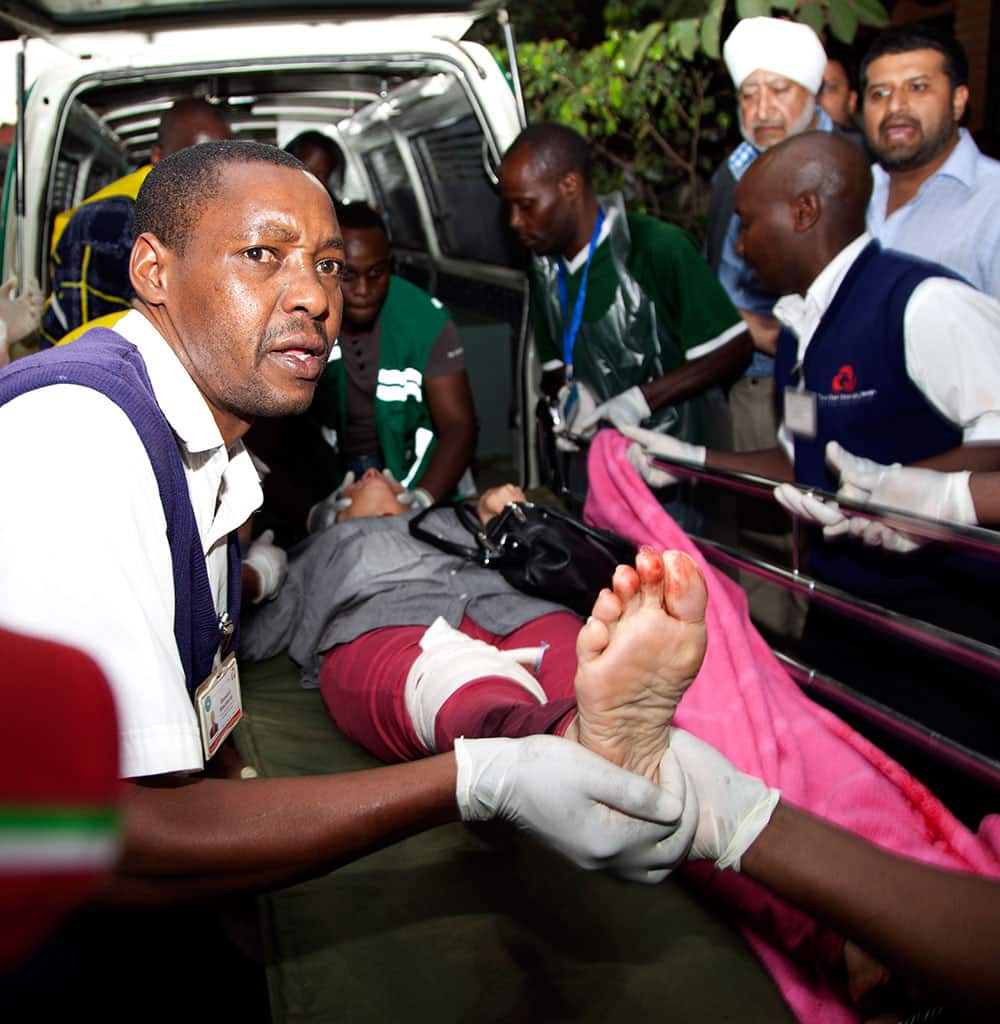 An injured person is helped on his arrival at the Aga Khan Hospital in Nairobi after an attack at the Westgate Mall, an upscale shopping mall in Nairobi, Kenya.
