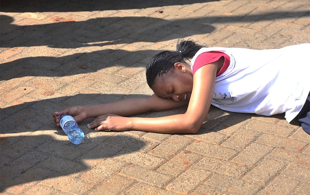 A rescued hostage collapses on the ground after being freed by police at Westgate Mall in Nairobi, Kenya.
