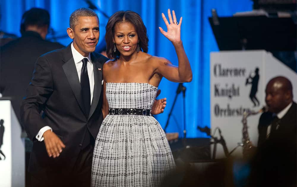 President Barack Obama and first lady Michelle Obama wave as they depart the stage after Obama addressed the 43rd annual Congressional Black Caucus Foundation`s Legislative Conference dinner in Washington.