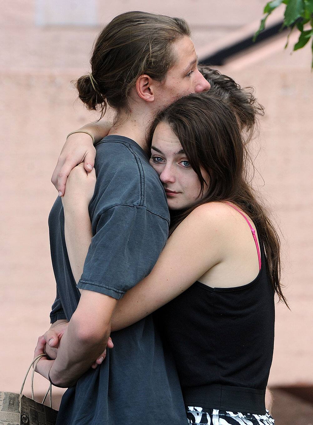 Mourner Jason Jones hugs Hannalee Chatham during the memorial service. A memorial service for Wiyanna Nelson and Wesley Quinlan was held at NCAR in Boulder, Colo.