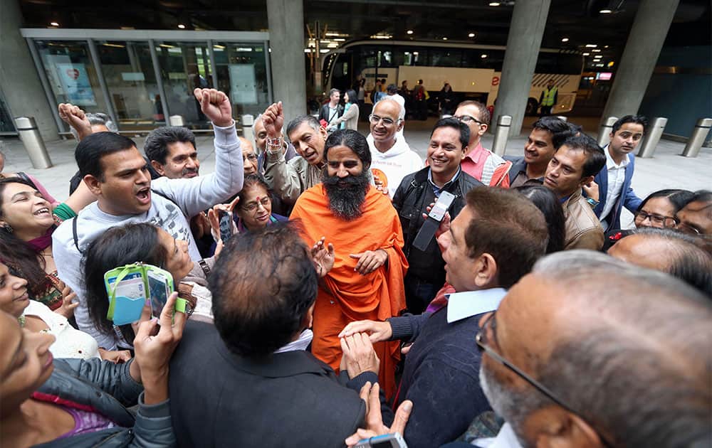 Yoga Guru Swami Ramdevji is greeted by supporters at Terminal 5 of London`s Heathrow Airport, after a meeting with immigration officials. Ramdevji, who is also known as Baba Ramdev has a reported 85 million strong worldwide following, was detained at Heathrow airport for eight hours after arriving from India, has now been allowed to stay in the country.
