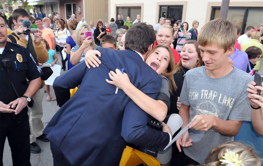 Actor Hugh Jackman hugs Lilly Bandow, 12, of Alden, Iowa during his appearance in Iowa Falls for the reopening of the Metropolitan Theater in Iowa Falls.