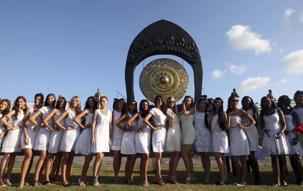 Miss World contestants pose for photos during the International World Peace Day celebrations at a park in Denpasar, Bali, Indonesia.