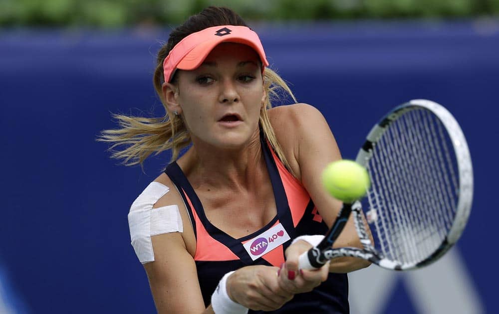 Agnieszka Radwanska of Poland returns a shot against Vera Dushevina of Russia during their quarterfinal match of the Korea Open tennis championships in Seoul.