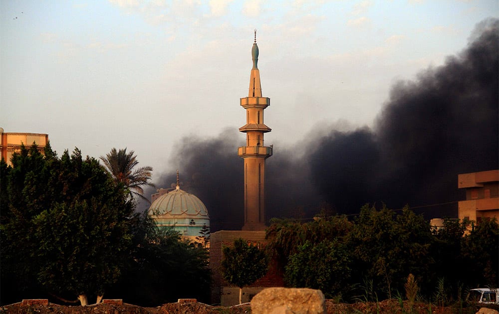 Smoke rises during clashes between Egyptian security forces and suspected militants, not pictured, in the town of Kerdasa, near Giza Pyramids, Egypt.