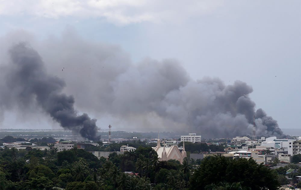Smoke rises in sporadic fighting between government forces and Muslim rebels in Zamboanga city in southern Philippines.