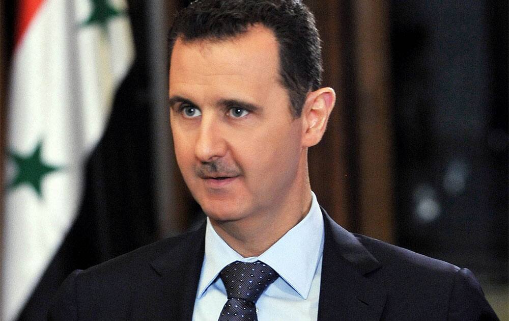 Syrian President Bashar Assad listens during an interview at the presidential palace in Damascus, Syria. Assad says a U.N. report that found