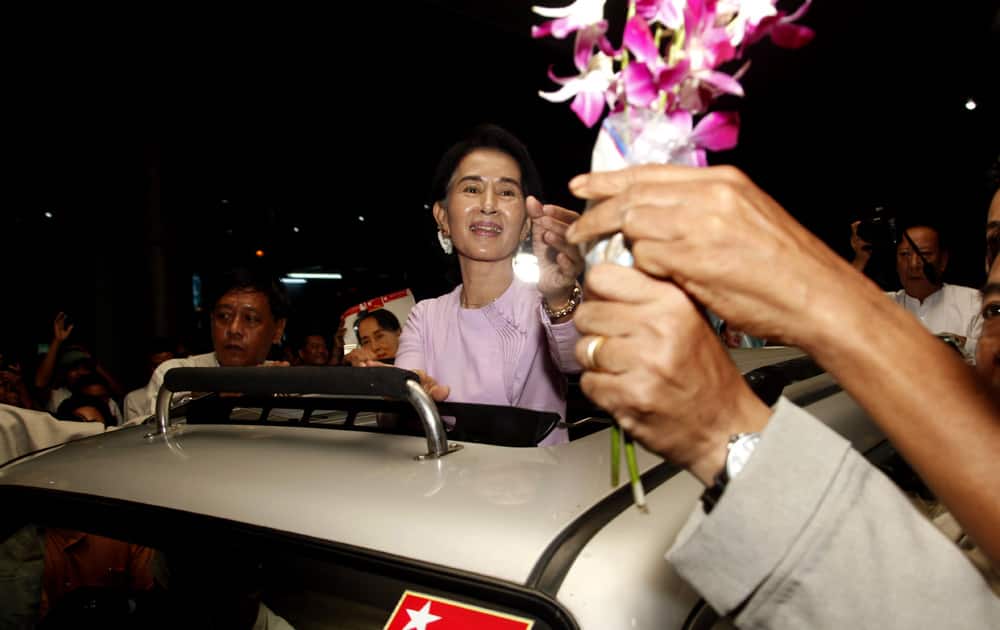 Myanmar opposition leader Aung San Suu Kyi receives flowers upon her arrival at Yangon International Airport after returning from Europe.