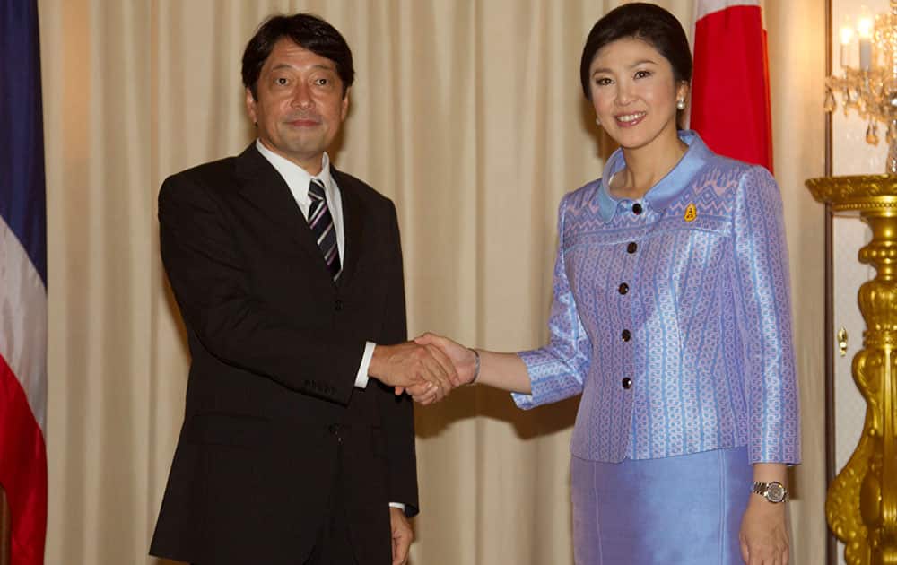 Japan`s Defense Minister Itsunori Onodera shakes hands with Thai Prime Minister Yingluck Shinawatra at Government House in Bangkok.