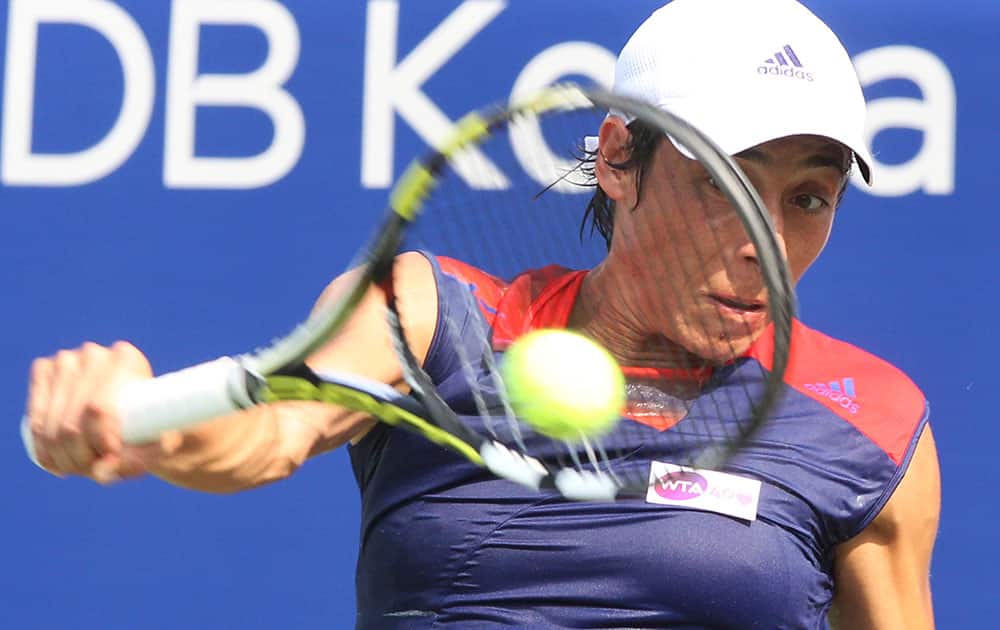 Italy`s Francesca Schiavone returns a shot against France`s Virginie Razzano during the second round match of the Korea Open tennis championships in Seoul, South Korea.