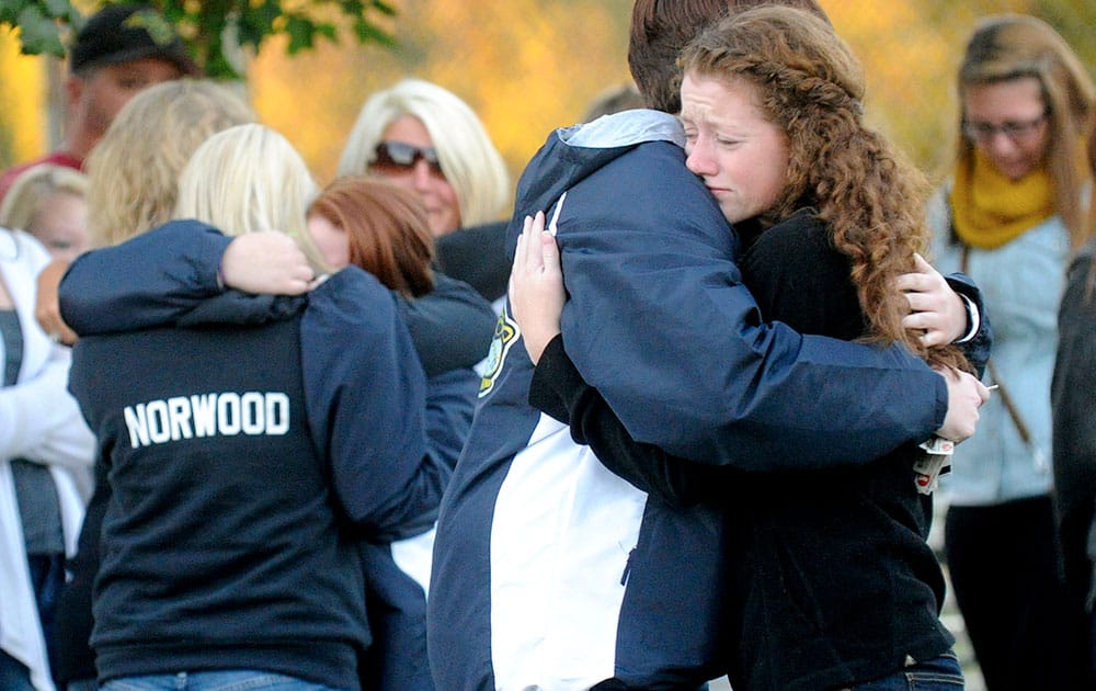 Savannah Walker, right, hugs Alex James during a candlelight vigil in honor of Richard Michael Ridgell at Jaycee Park in Westminster, Md.
