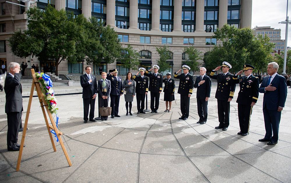 This photo provided by the Navy Media Content Service shows Secretary of Defense, Chuck Hagel, right, Gen. Martin E. Dempsey, Chairman of the Joint Chiefs of Staff, Adm. Jonathan Greenert, Chief of Naval Operations, Ray Mabus, Secretary of the Navy, and Adm. James A. Winnefeld Jr., Vice Chairman of the Joint Chiefs of Staff, render honors on Tuesday, Sept. 17, 2013, during a wreath laying ceremony at the US Navy Memorial.