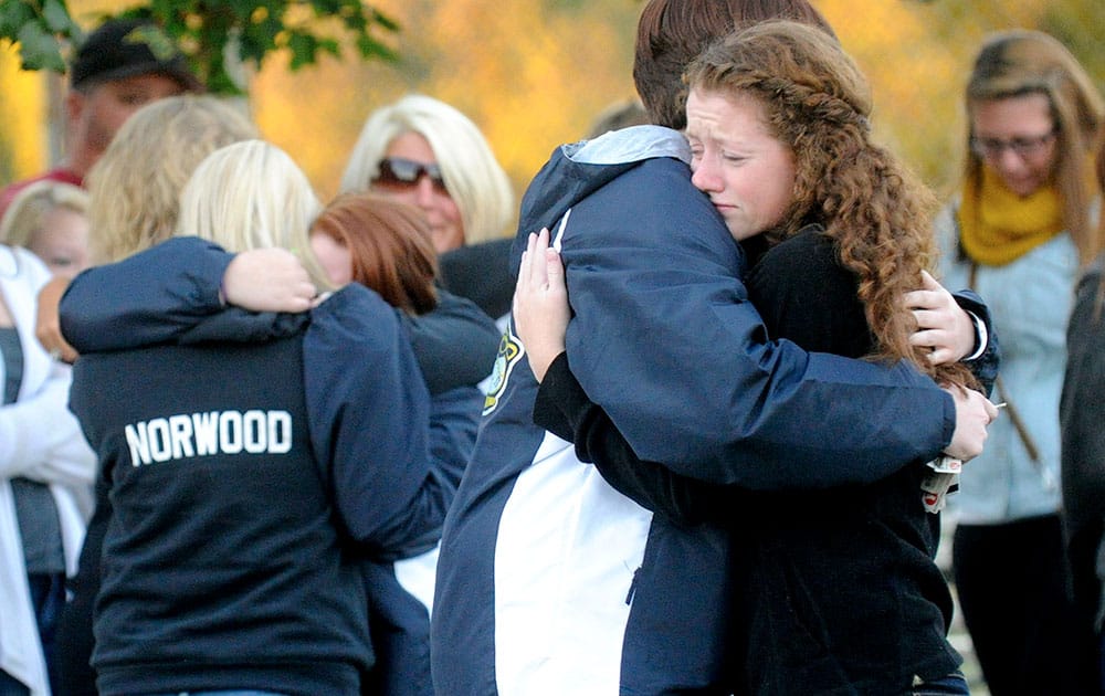 Savannah Walker, right, hugs Alex James during a candlelight vigil in honor of Richard Michael Ridgell at Jaycee Park in Westminster, Md.