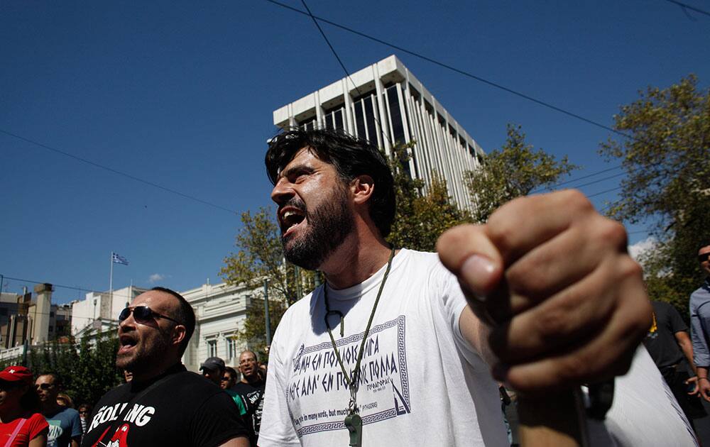 Municipal Police officers shout slogans in front of the Greek Parliament during a protest in Athens.