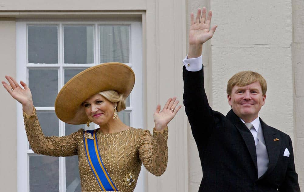 Netherlands` King Willem-Alexander and his wife Queen Maxima wave to well wishers from the balcony of Noordeinde Palace.