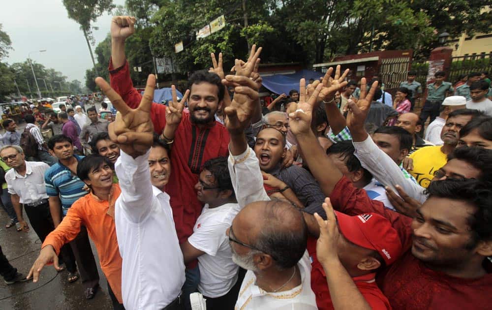 Bangladeshi activists shout slogans and celebrate the verdict against Jamaat-e-Islami party leader Abdul Quader Mollah in Dhaka.