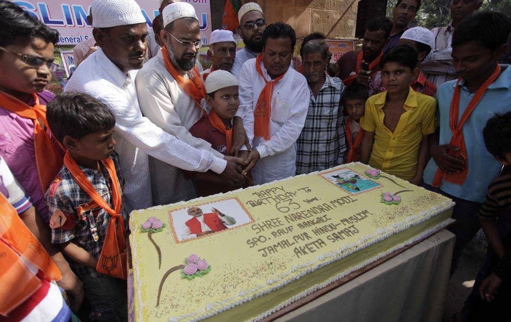 Muslim supporters of BJP prepare to cut a cake as they celebrates the birthday of Gujarat state chief minister Narendra Modi in Ahmedabad.