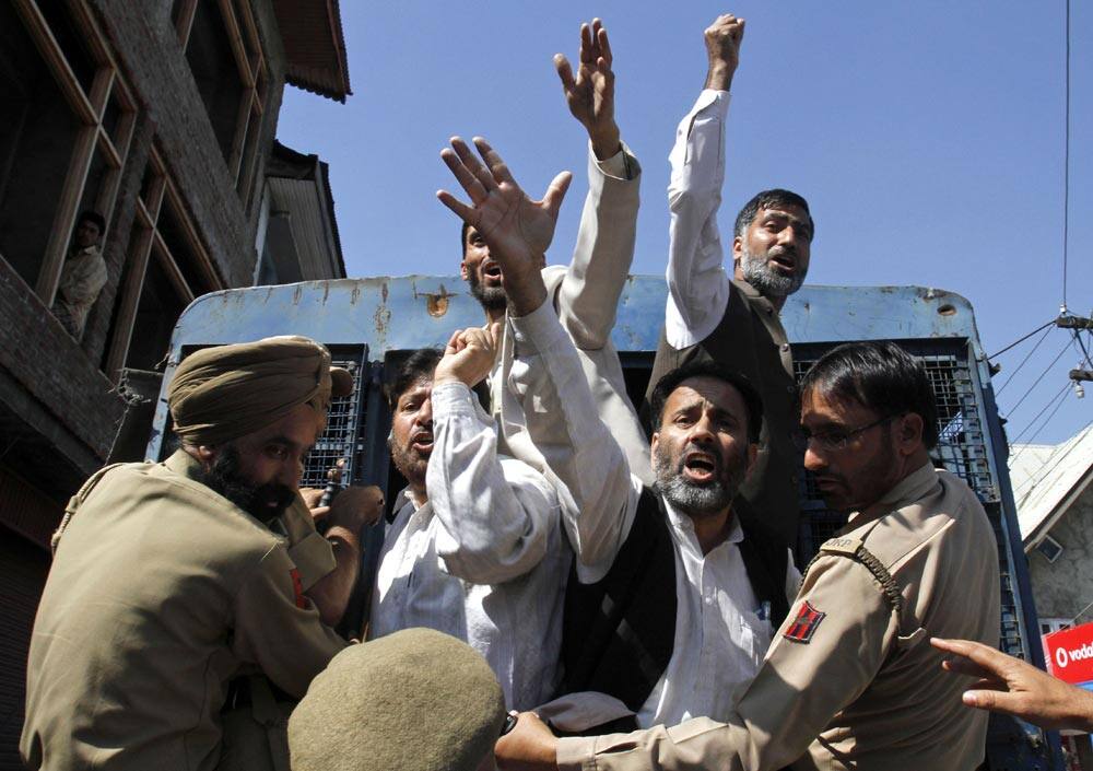 Activists of All Parties Hurriyat Conference shout slogans after being detained during a protest in Srinagar.