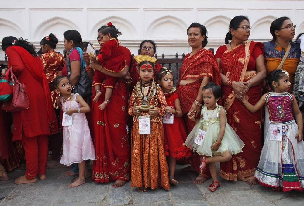 Young Nepalese girls with their mothers wearing new cloths wait for Kumari puja at Hanuman Dhoka, Basantapur Durbar Square, Katmandu.