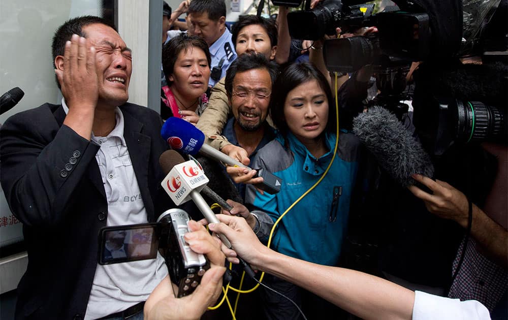Ji Zhongji slaps his face in grief as he speaks to journalists about his brother Ji Zhongxing who is on trial for endangering public safety by setting off an explosion two months ago at Beijing`s airport, outside a courthouse in Beijing, China.