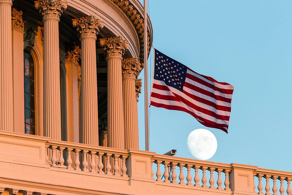 The American flag flies at half-staff over the US Capitol at sunset following the shooting at the Washington Navy Yard, in Washington.