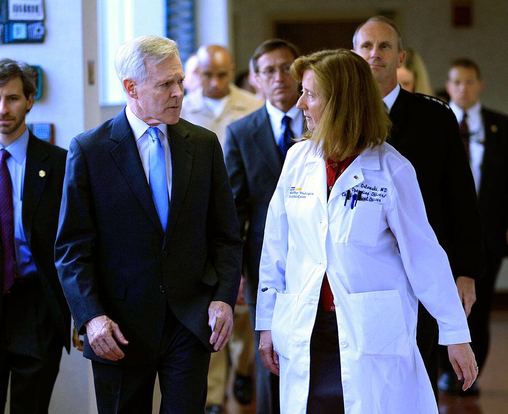Secretary of the Navy Ray Mabus speaks with Dr. Janis M. Orlowski as they walk in the corridor at Washington Hospital Center, in Washington.
