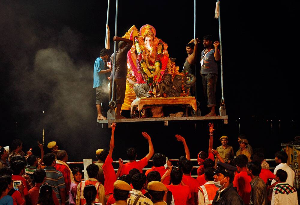 An idol of Hindu god Ganesha is lifted to be immersed in the Hussain Sagar Lake during Ganesh Chaturthi festival celebrations in Hyderabad.