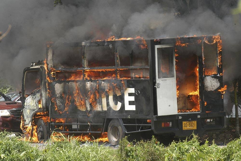 A police truck burns during a clash between rubber farmers and anti-riot police in Nakhon Sri Thammarat, southern of Thailand.