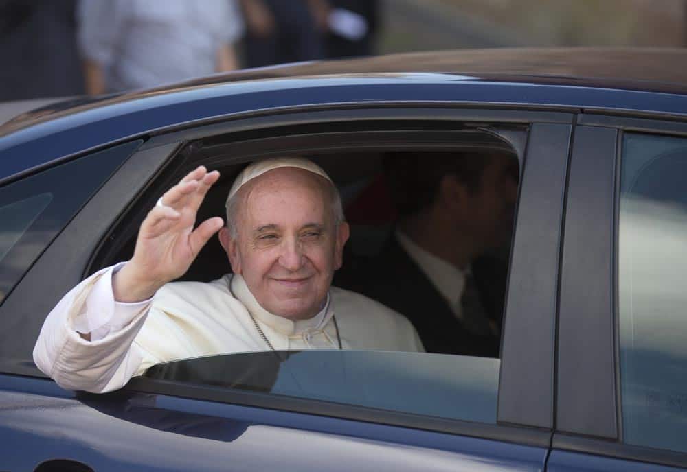 Pope Francis waves as he leaves St. John Lateran Church after a private meeting with the Roman Clergy, in Rome.