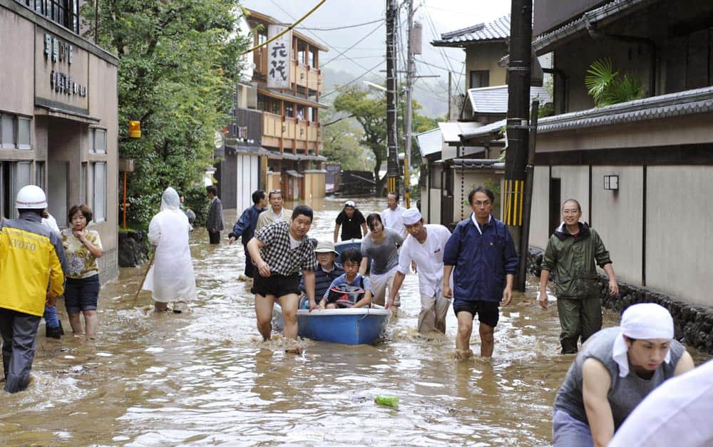 Hotel guests get a boat ride through a flooded street after the Katsura River was overflooded by torrential rains caused by a powerful typhoon in the country`s popular tourist destination of Kyoto, western Japan.