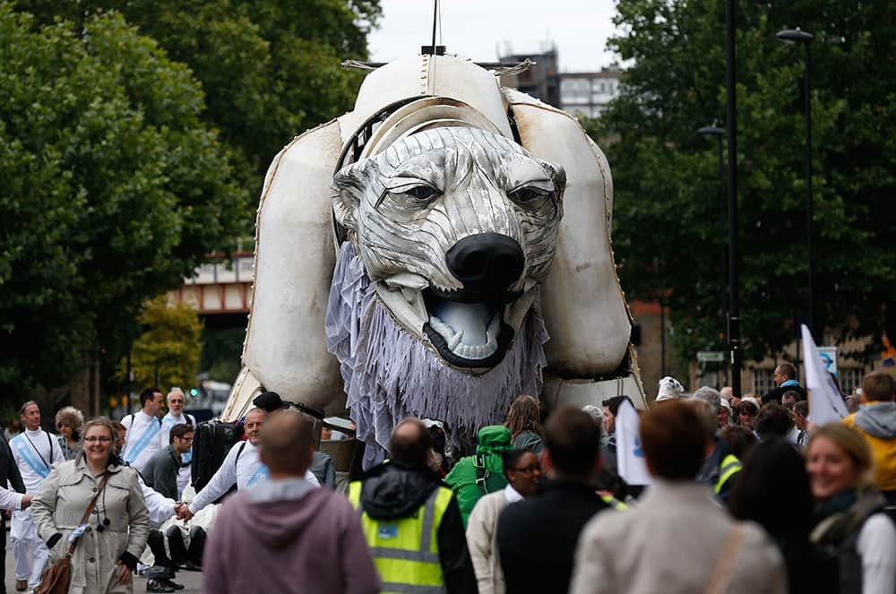 Environmental activists prepare to move a giant marionette polar bear named `Aurora` in a parade through central London to protest against oil companies exploiting the Arctic.