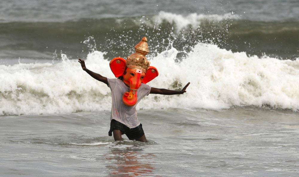 An unidentified man wearing the head of an idol of elephant-headed Hindu god