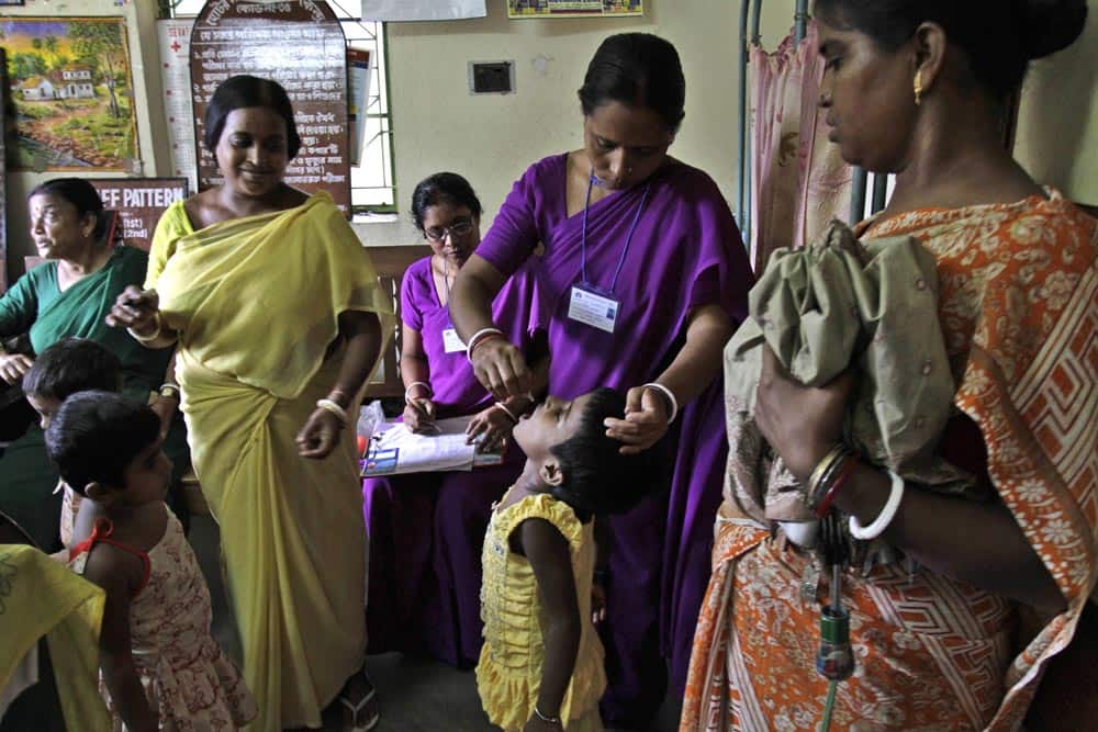 A health worker administers polio vaccine to a child at a health center in Dhamua, outskirts of Kolkata.