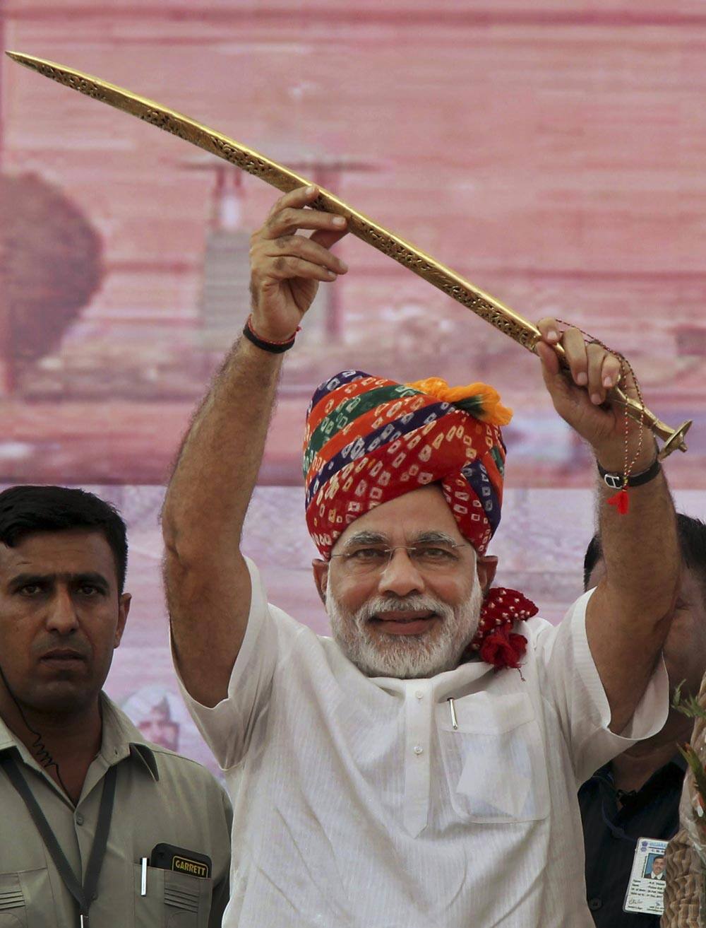 Gujarat Chief Minister Narendra Modi raises a sword that was presented to him at a rally in Rewari, Haryana state.