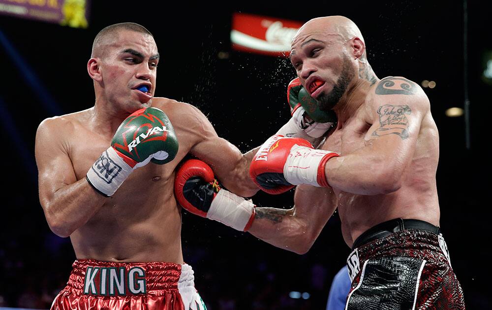 Carlos Molina, left, lands a punch against Ishe Smith in the tenth round during an IBF junior middleweight title fight, in Las Vegas.