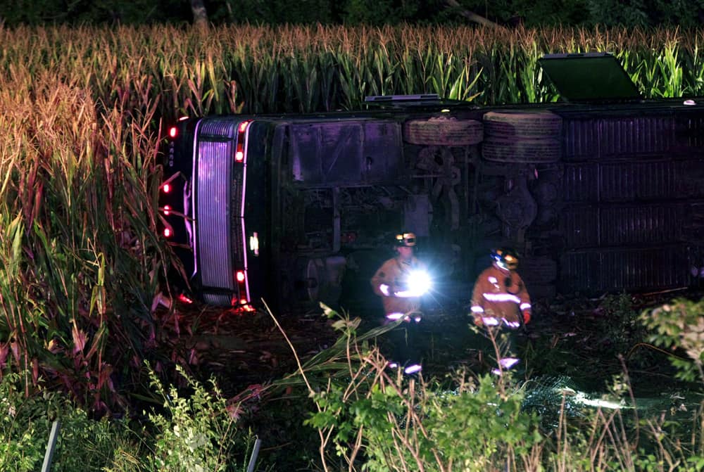 Officials work the scene of an overturned Greyhound bus on interstate I-75 in Liberty Township, Ohio. Authorities say that at least 34 people have been hurt, with injuries ranging from minor to severe.