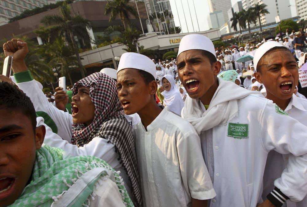 Indonesian Muslim youths chant slogans during a rally demanding the cancellation of Miss World pageant in Jakarta, Indonesia.