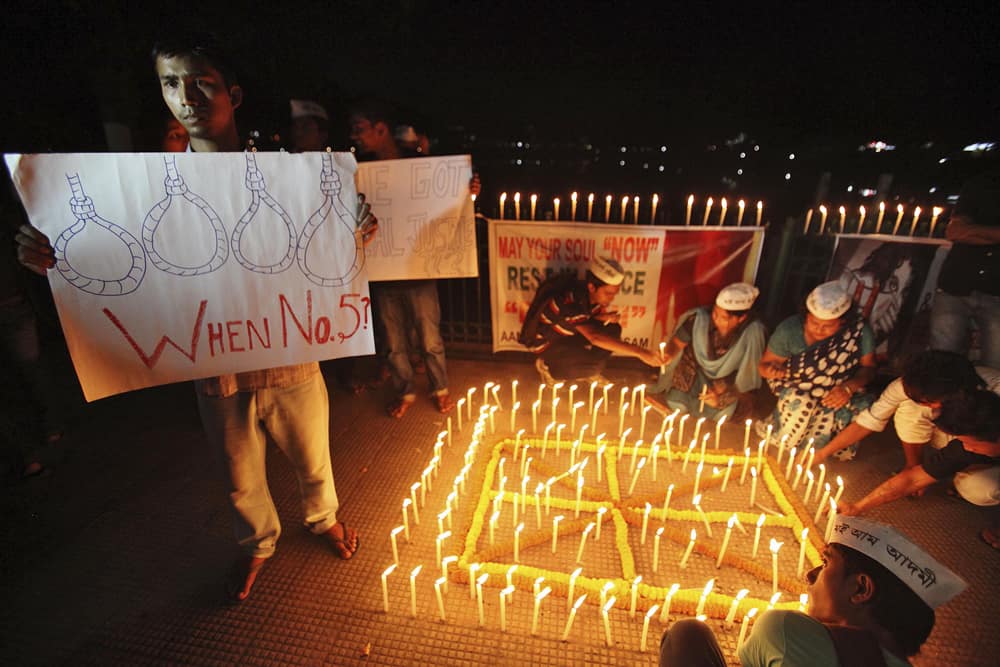People light candles to mark the verdict after a judge pronounced death sentences for four men convicted in the rape and murder of a student on a moving bus in New Delhi last year, in Guwahati.