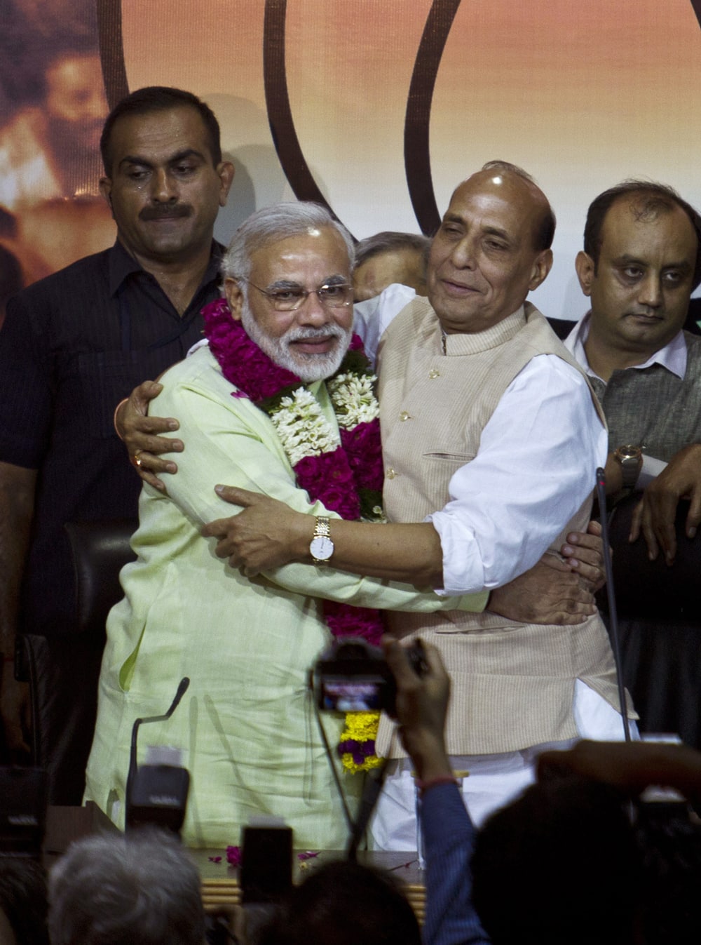 Bharatiya Janata Party (BJP) president Rajnath Singh hugs Gujarat state Chief Minister Narendra Modi after garlanding him in New Delhi.
