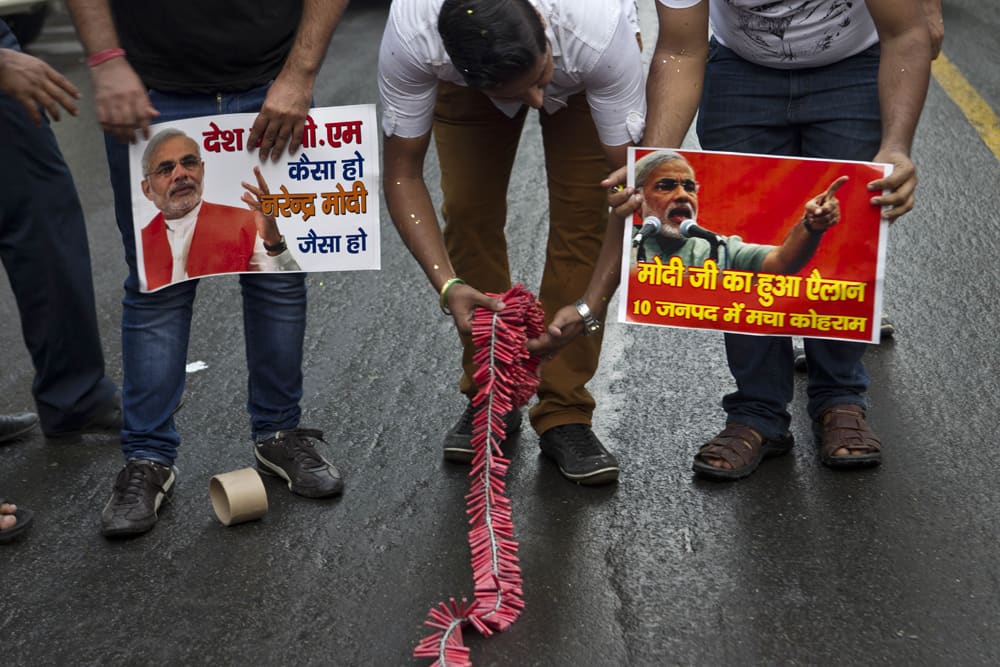 Supporters of Bharatiya Janata Party (BJP) lay out a roll of crackers on a road to celebrate after Gujarat state Chief Minister Narendra Modi was appointed as the party`s prime minister candidate for 2014 polls, in New Delhi.