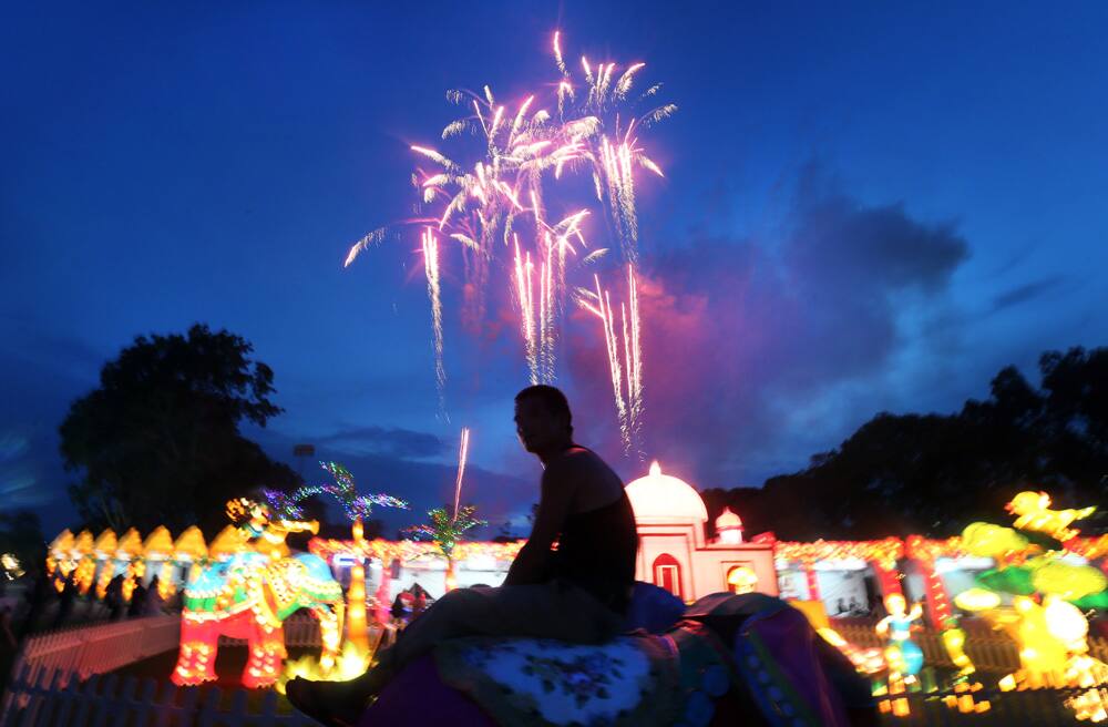 A man is silhouetted against an explosion of fireworks at the Gardens By The Bay in Singapore during the launch of the Mid-Autumn Festival celebrations, an annual traditional celebration celebrated by local Chinese in the city-state.