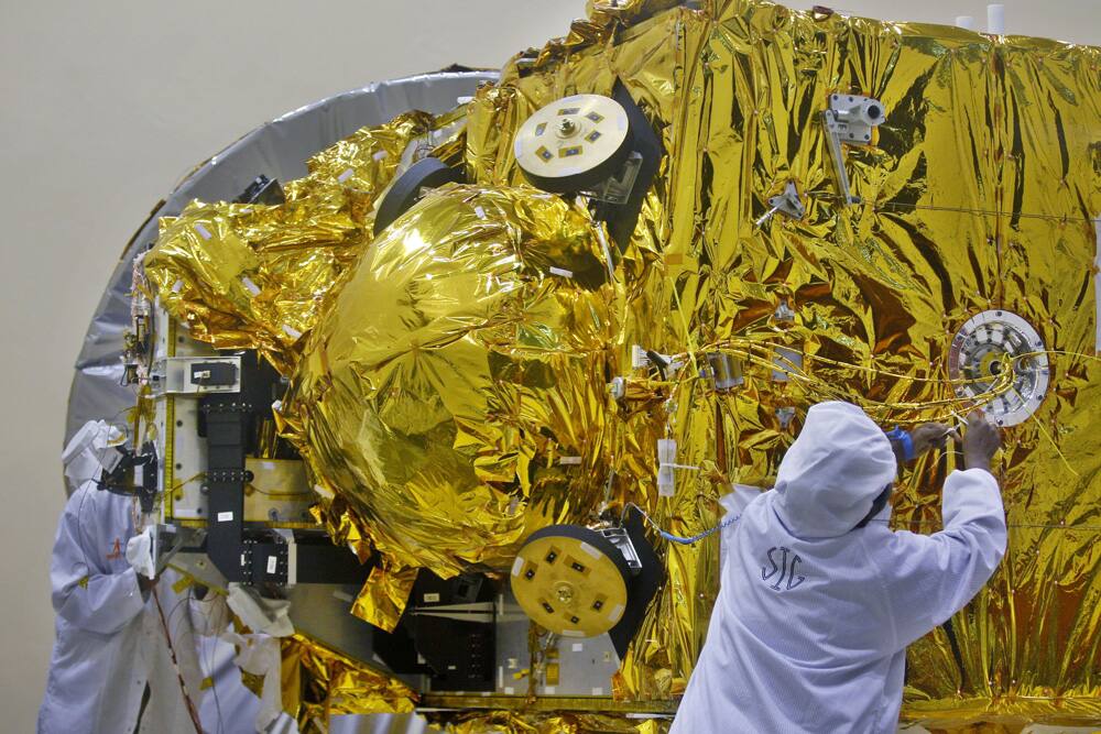 Engineers work on the Mars orbiter spacecraft at the satellite center of Indian Space Research Organization (ISRO) in Bangalore.