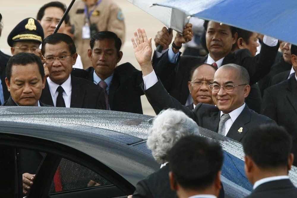 Cambodia`s King Norodom Sihamoni waves to government officers as he returns from Beijing at Phnom Penh International Airport, in Phnom Penh, Cambodia.