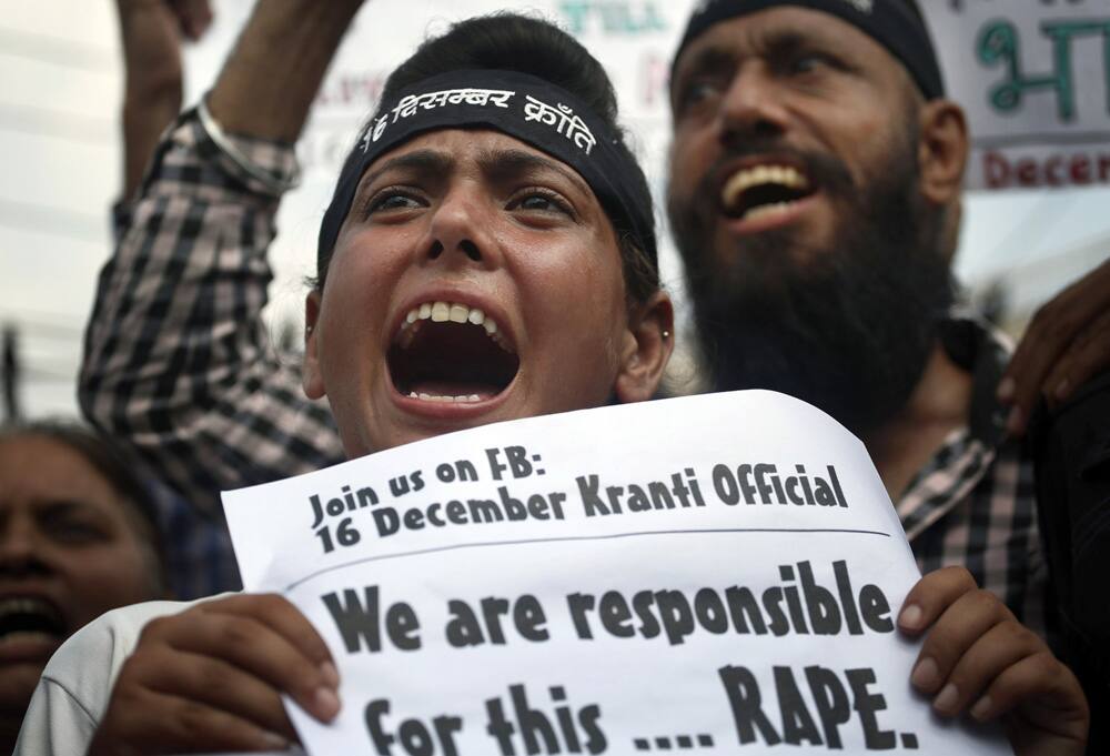 Protestors shout slogans demanding the four men convicted in the fatal gang rape of a young woman on a moving New Delhi bus last year, be sentenced to death outside a court in New Delhi.