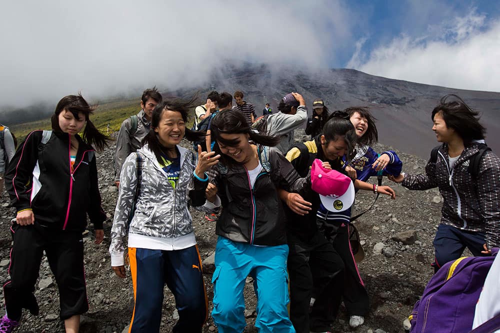 Japanese students make their way down a steep trail on Mount Fuji in Japan during a school putting to learn about the mountain environment and pick up any trash they could find on the trails.