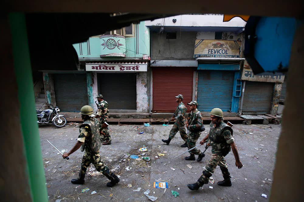 Indian army soldiers patrol during a curfew imposed following deadly clashes between Hindus and Muslims at Muzaffarnagar in Uttar Pradesh state, India.