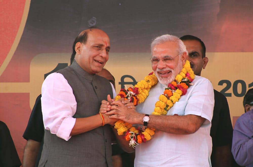 Bharatiya Janata Party (BJP) president Rajnath Singh, left, greets Gujarat state Chief Minister Narendra Modi after garlanding him at a political rally in Jaipur.